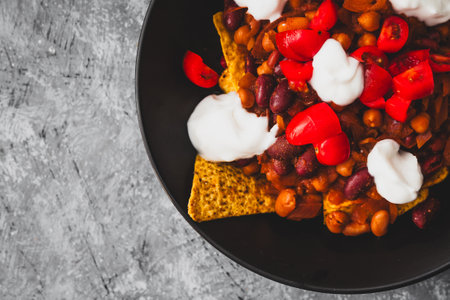 healthy  bean nachos with tomato salsa and coconut yoghurt, healthy vegan food recipesの写真素材