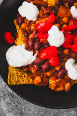 healthy  bean nachos with tomato salsa and coconut yoghurt, healthy vegan food recipesの写真素材