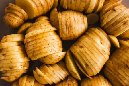 plant-based hasselback potatoes about to go in the oven, healthy vegan food recipesの写真素材