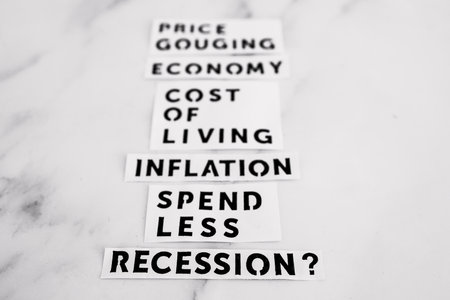 Inflation and recession conceptual image, economic terms on marble desk fading away from the cameraの写真素材