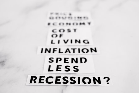 Inflation and recession conceptual image, economic terms on marble desk fading away from the cameraの写真素材