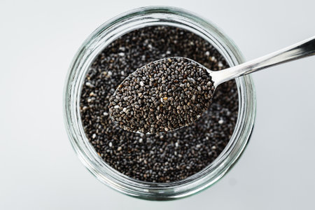 pantry staple close-up, spoonful of chia seeds  over clear glass jar shot from above, daily ingredientsの写真素材