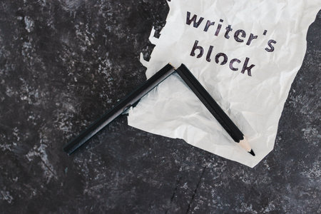 writer's block and overwhelm from deadlines conceptual image with broken pencil and scrunched up paper with text, productivity and stressの写真素材