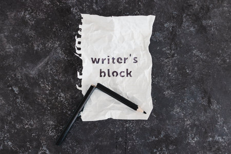 writer's block and overwhelm from deadlines conceptual image with broken pencil and scrunched up...