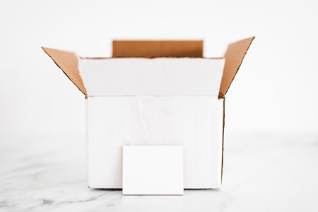 white open box or parcel with blank label in front of it, copy space to add text, concept of...