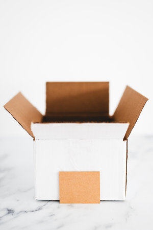 white open box or parcel with blank label in front of it, copy space to add text, concept of...