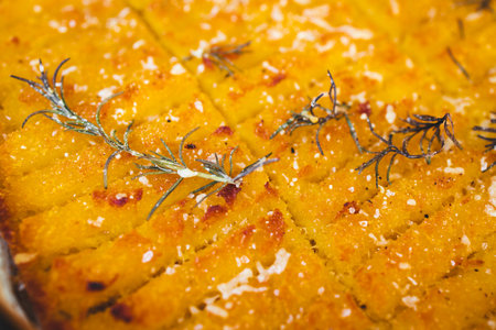 crispy golden polenta chips with rosemary roasted in the oven on a tray, delicious and homemadeの写真素材