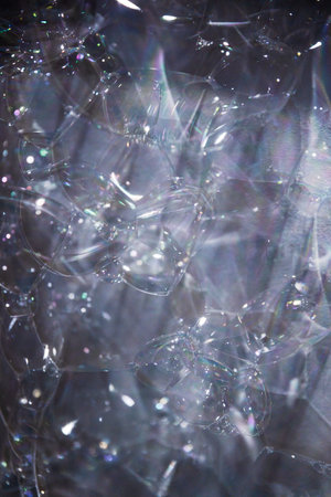 extreme close-up of soap bubbles on a white wall, ideal as background or texture overlay