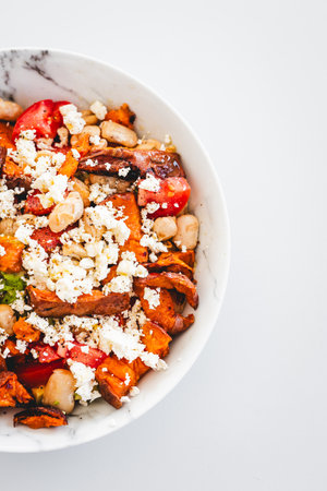 nourishing salad with white beans, roasted sweet potato, tomato, avocado, and feta, perfect for...