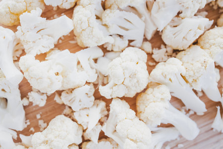 fresh chopped cauliflower on a rustic wooden cutting board, healthy recipes, diabetes-friendly meal prep and plant-based cooking themesの写真素材