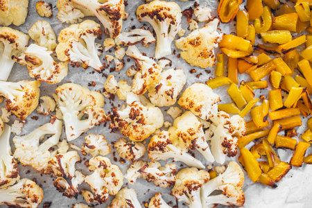 roasted cauliflower and yellow capsicum on baking tray forhealthy recipes theme, prediabetes and diabetes-friendly mealsの写真素材