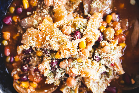 homemade onion soup with beans, corn, and parmesan topping, a hearty and wholesome vegetarian meal...