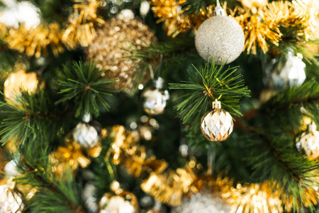 christmas tree with golden and silver decorations including stars and tinsel, concept of festive holiday season, cozy home decor, and sparkling winter celebration atmosphereの写真素材