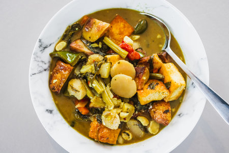 vegetarian green curry made with tofu and mixed vegetables in a creamy aromatic sauce, showcasing plant based cooking, thai inspired flavours and healthy homemade comfort foodの写真素材