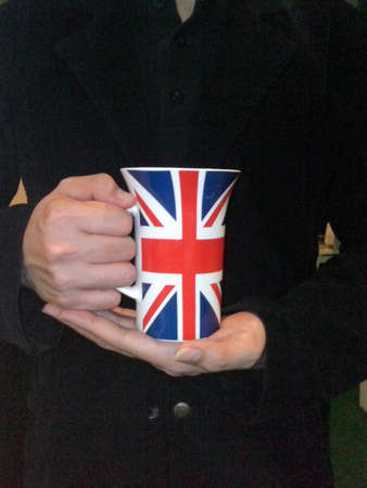 Hand holding british mugの素材