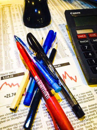 Business investment concept of stock and share market with calculator and pensの素材