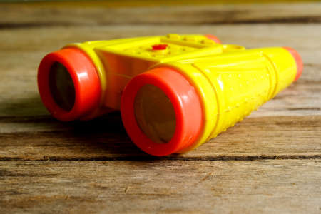 Selective focus of binocular type of water gun toys for kids on wooden background.の写真素材