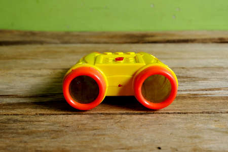 Selective focus of binocular type of water gun toys for kids on wooden background.の写真素材