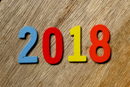 Top view of Colorful wooden number 2018 on wooden background for blog title and header. New year...