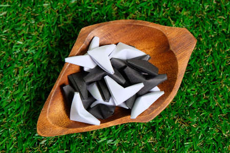 Black and white heart origami on grass background. Valentine's day theme.