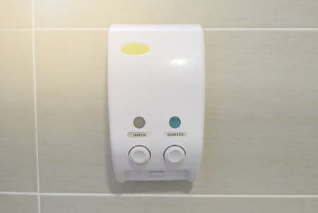 Liquid soap and shampoo dispenser in a bathroomの写真素材