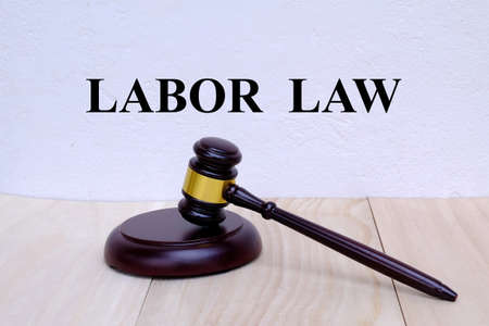 Labor Law written on the wall with gavel on wooden background. Law concept.の写真素材