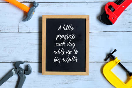 Inspirational motivating quotes written on blackboard. A Little Progress Each Day Adds Up To Big Resultsの写真素材