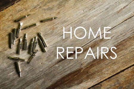 Home repairs written on wooden background with screwdriver.の写真素材