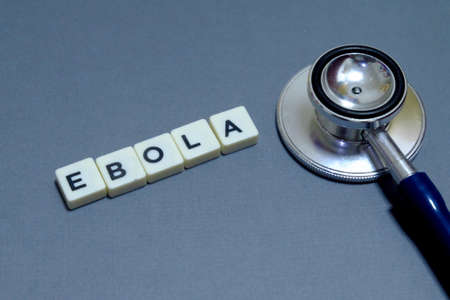 Stethoscope and letter of Ebola on grey background. Healthcare and Medical concept.の写真素材
