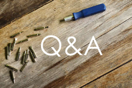 Questions and answers concept. Q&A. Screwdrivers on wooden background.