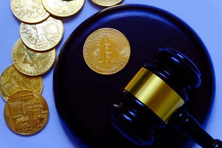 Law or auction concept with gavel and replica of gold bitcoin.Bitcoin cryptocurrency Internet business technology theme.の写真素材