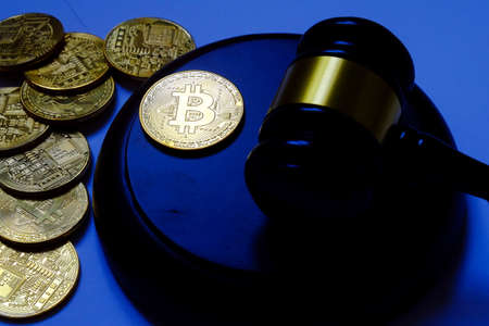 Law or auction concept with gavel and replica of gold bitcoin.Bitcoin cryptocurrency Internet...