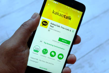 BANDAR SERI BEGAWAN,BRUNEI - JULY 25TH,2018 : A male hand holding smartphone with Kakaotalk apps on an android Google Play Storeのeditorial素材