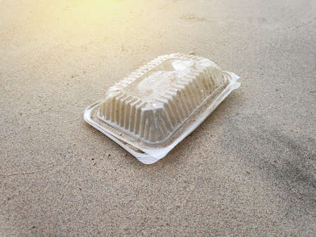 Plastic trash or garbage by the beach with sun flare. Pollution and recycle concept.の写真素材