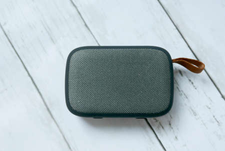 Speaker on white wooden background.