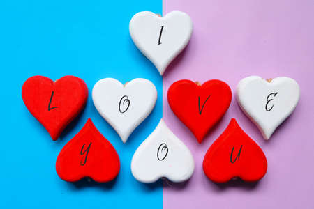 Red and white wooden heart written with I Love You.