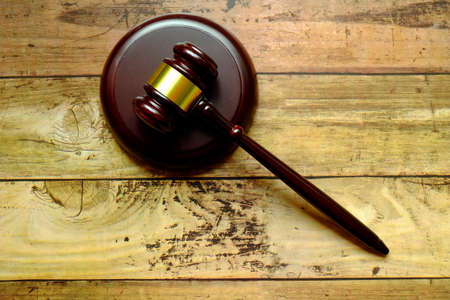Top view of gavel on wooden background.の写真素材