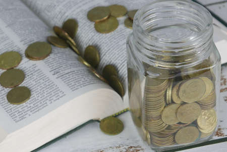 Selective focus of Gold coins on book. Finance and education concept.の写真素材