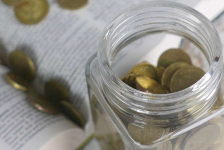 Selective focus of Gold coins on book. Finance and education concept.