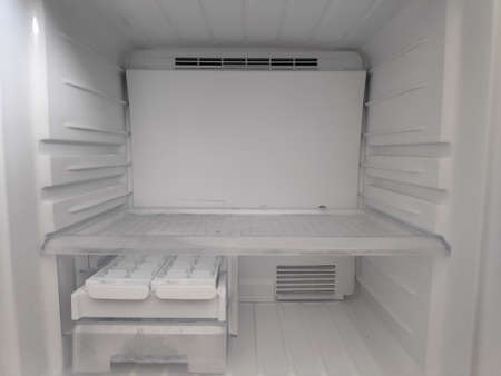 Empty refrigerator shelves closeup. Freezer chamber.