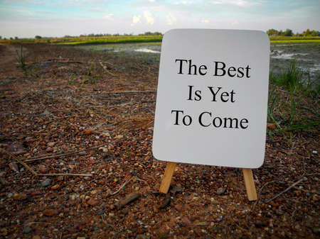 Inspirational motivational quotes written on white board with nature background. The best is yet to come.の写真素材