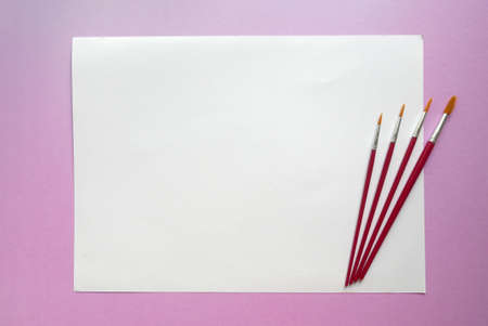 Watercolor brush on white paper background lay on pink background. Copy paste for text, logo and etc.の写真素材