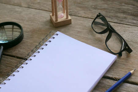 Notebook with stationery on wooden background. Copy space for text or logo.の写真素材