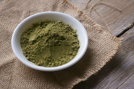 Stevia powder in white plate on rug sack on wooden background.の写真素材