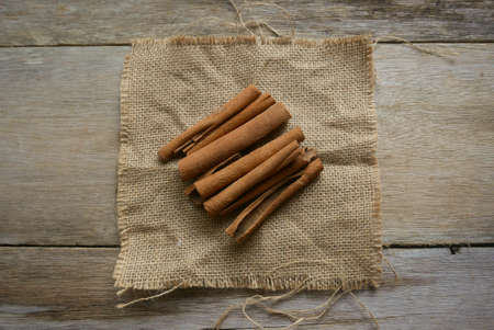 Cinnamon stick on rug sack on wooden background.の写真素材