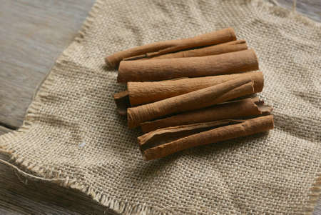 Cinnamon stick on rug sack on wooden background.の写真素材