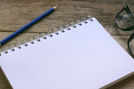 Notebook with stationery on wooden background. Copy space for text or logo.の写真素材