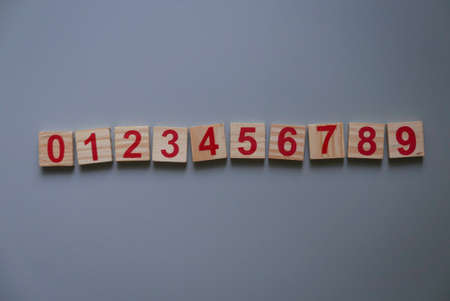 Top view of a wooden numbers zero to ten on grey background.の写真素材