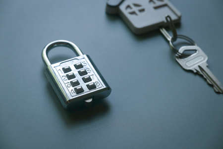 Padlock,key holder with key on gray background. Property,insurance and security concept.