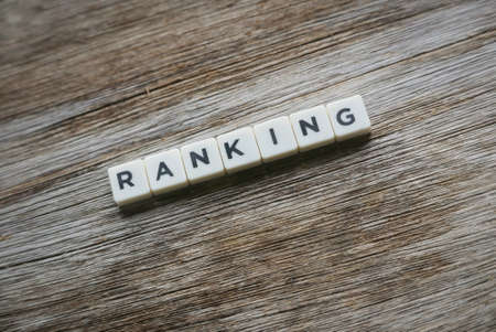 Ranking word made of square letter word on wooden background.